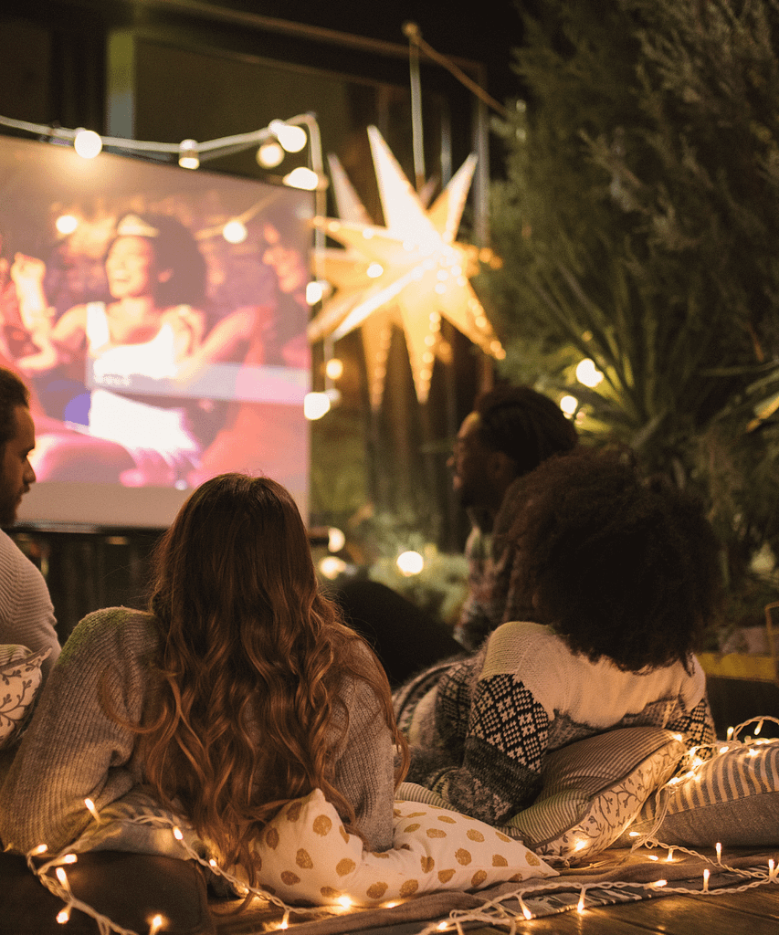 a group of people sitting on the floor watching a movie